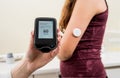 Medical device for glucose check. Continuous glucose monitoring pod. Royalty Free Stock Photo