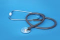 Medical device for listening stethoscope on a blue background, concept of medicine and healthcare, top view, close-up, copy space Royalty Free Stock Photo