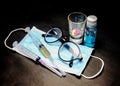 Medical devices, syringes, tablets, alcohol masks, glasses on black background