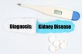 Medical diagnosis. On paper a thermometer, pills and a hole, inside which the inscription - Kidney Disease Royalty Free Stock Photo