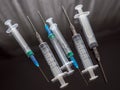 Medical disposable syringes with needles on a dark surface Royalty Free Stock Photo