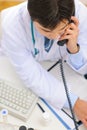 Medical doctor dialing phone number. Upper view