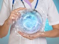 Medical Doctor holding a world globe in her hands as medical network concept Royalty Free Stock Photo