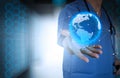 Medical Doctor holding a world globe in his hands Royalty Free Stock Photo