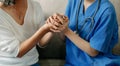 .medical doctor holing patient's hands and comforting her.Kind doctor giving real support for patient Royalty Free Stock Photo