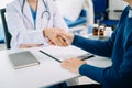 medical doctor holing patient's hands and comforting her.Kind doctor giving real support for patient. In clinic Royalty Free Stock Photo