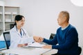 medical doctor holing patient\'s hands and comforting her.Kind doctor giving real support for patient. In clinic Royalty Free Stock Photo