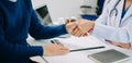 medical doctor holing patient's hands and comforting her.Kind doctor giving real support for patient. In clinic Royalty Free Stock Photo