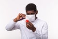 Medical doctor or laborant holding tube with Coronavirus vaccine for COVID-19. Coronavirus model in human hand. Vaccine
