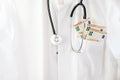 Medical doctor or physician coat with stethoscope and euro money in the pocket, healthcare costs and corruption concept with copy Royalty Free Stock Photo