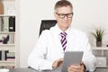 Medical Doctor Reading Reports Using Tablet Royalty Free Stock Photo