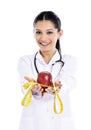 Medical doctor showing apple and measurement Royalty Free Stock Photo