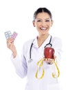 Medical doctor showing apple and pils Royalty Free Stock Photo