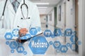 Medical Doctor with stethoscope and Medicare icon in Medical net