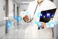 Medical Doctor with stethoscope and Medicare icon in Medical network connection on the virtual screen on hospital background.