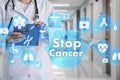 Medical Doctor with stethoscope and Stop Cancer sign in Medical network connection on the virtual screen on hospital background.Te Royalty Free Stock Photo