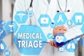 Medical Doctor with stethoscope and MEDICAL TRIAGE sign in Medical network connection on the virtual screen on hospital background Royalty Free Stock Photo