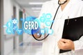 Medical Doctor with stethoscope and word GERD, Gastroesophageal reflux disease in Medical network connection on the virtual screen Royalty Free Stock Photo