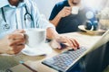 Medical doctor team taking coffee break.using digital tablet doc Royalty Free Stock Photo