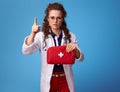 Medical doctor woman with first-aid kit drawing attention Royalty Free Stock Photo