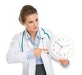 Medical doctor woman pointing on clock Royalty Free Stock Photo