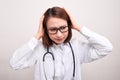 Medical doctor woman with stethoscope problem, hold hand head on white background Royalty Free Stock Photo