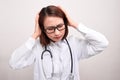 Medical doctor woman with stethoscope problem, hold hand head on white background Royalty Free Stock Photo