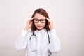 Medical doctor woman with stethoscope problem, hold hand head on white background Royalty Free Stock Photo