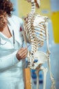 Medical doctor woman teaching anatomy using human skeleton Royalty Free Stock Photo