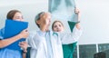 Medical doctors looking at x-rays in a hospital .checking chest x ray film at ward with nurse and female doctor Surgeon. Royalty Free Stock Photo