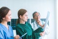 Medical doctors looking at x-rays in a hospital .checking chest x ray film at ward with nurse and female doctor Surgeon. Royalty Free Stock Photo