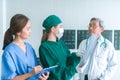 Medical doctors looking at x-rays in a hospital .checking chest x ray film at ward with nurse and female doctor Surgeon. Royalty Free Stock Photo