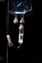 Medical drip bag on the dark background Royalty Free Stock Photo