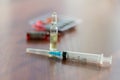 Medicines, injectable ampoules and syringe on the table