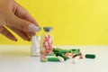 Medical drugs taplets in jars in the hand of a girl holding