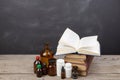 Medical education concept - books, pharmacy bottles, stethoscope in the auditorium with blackboard Royalty Free Stock Photo