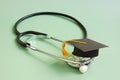 Medical education concept. Graduation cap and stethoscope. Royalty Free Stock Photo