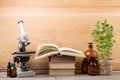 Medical education concept - microscope, books and pharmacy bottles Royalty Free Stock Photo