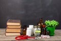 Medical education concept - money glass, books, pharmacy bottles Royalty Free Stock Photo