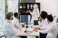 Medical education, health care and medicine concept. Team of multiethnic doctors having meeting in clinic, looking at Royalty Free Stock Photo