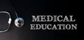 MEDICAL EDUCATION written in chalk on a dark background along with a stethoscope. Health care medicine concept. Top view, flat lay