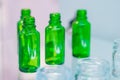 Medical empty glass green bottles in showcase at pharmaceutical exhibition