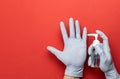 Medical equipment background. Medical alcohol sanitizer gel in lab gloves on red. Coronavirus disease. Clear sanitizer in pump Royalty Free Stock Photo