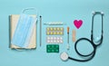 Medical equipment on a blue background. Blisters pills, notepad, stethoscope, syringe, thermometer, manometer. Medical concept, to Royalty Free Stock Photo