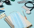 Medical equipment on a blue background. Enema, blisters pills, notepad, stethoscope, syringe, thermometer, manometer. Royalty Free Stock Photo