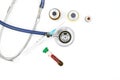 Medical equipment on doctor`s desk, stethoscope ampules and syringe on white background with copy space, close-up