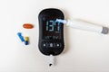 Medical equipment for measuring the level of blood glucose with lancing pen device on white background. Medical device for Royalty Free Stock Photo