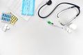 Medical equipment : pills, mask, thermometer and stethoscope on white background. Top view. Copy space Royalty Free Stock Photo