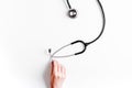 Medical equipment with stethoscope in doctor`s office on white desk background top view mock-up Royalty Free Stock Photo