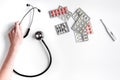 Medical equipment with stethoscope and pills in doctor`s office on white desk background top view mock-up Royalty Free Stock Photo